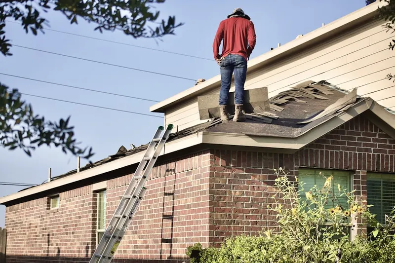 Professional roofer working on a residential roof in Steel Point